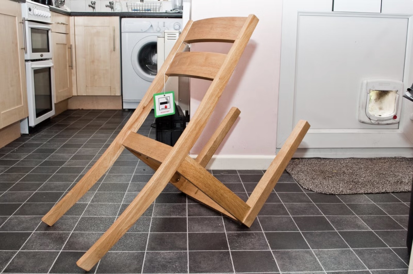 Incorrectly assembled wooden chair in kitchen, with legs attached to wrong side, illustrating data misinterpretation challenges.